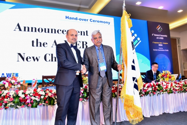 AWEB Flag being handed over to the new Chairman, CEC Sunil Arora by the Representative of Outgoing Chair, Mr. Ion Mincu Radulescu, Advisor, Permanent Election ACEC